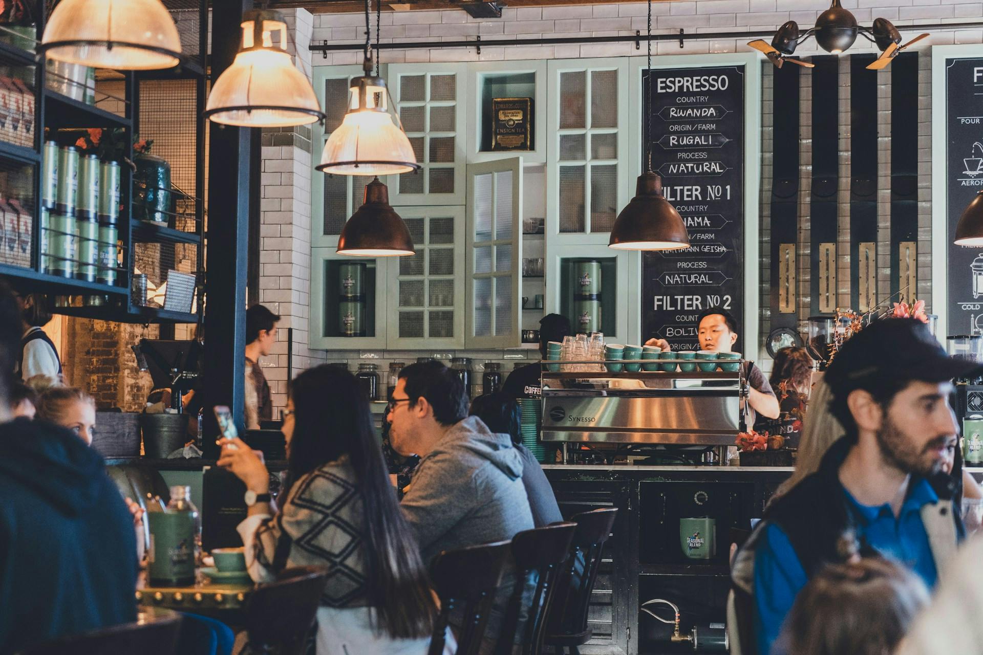 A busy restaurant or coffee place creates demand scarcity because its a popular place to be